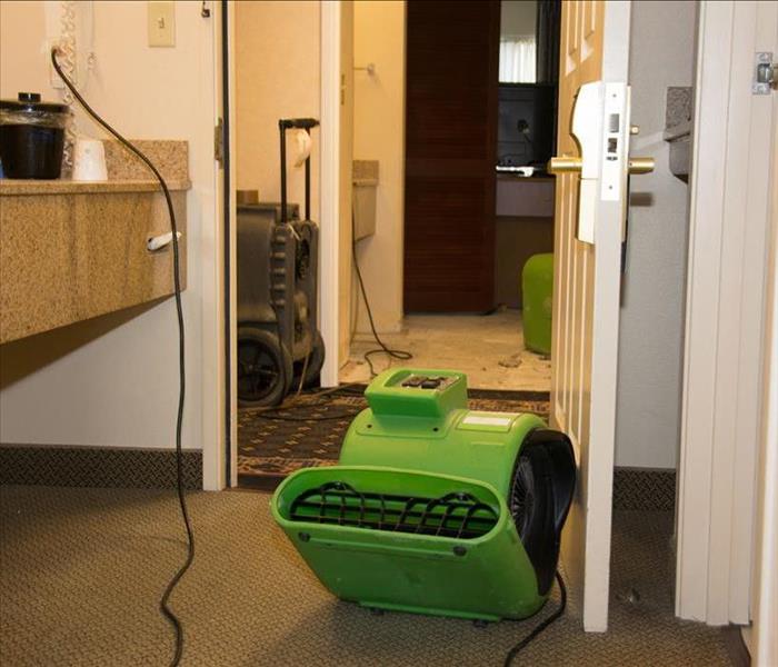 air mover and dehumidifier in a bathroom of motel