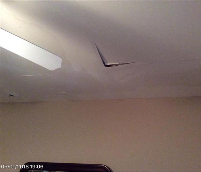 water stains on ceiling, broken panels are split